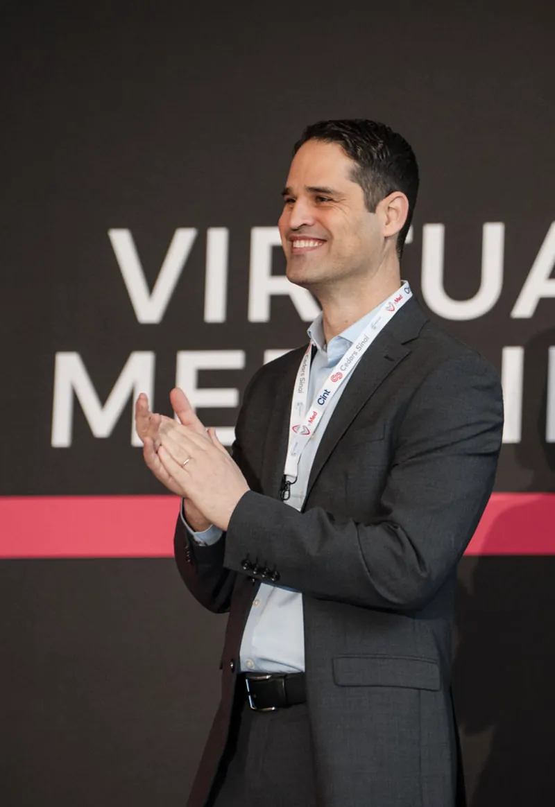 Omer Liran on stage at a virtual medicine conference